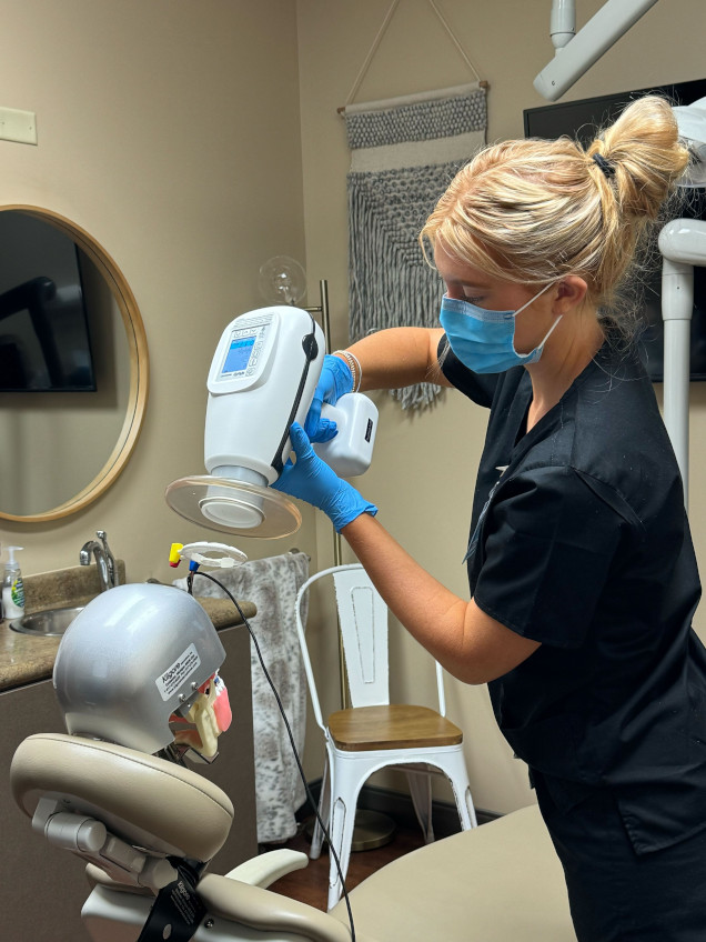 {{ school.name }} student training to take dental x-rays